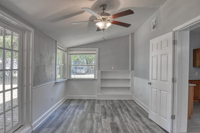 spare room with ceiling fan, wood-type flooring, and lofted ceiling