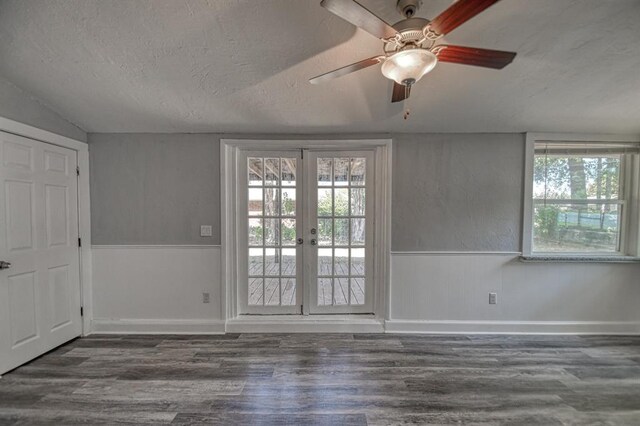 spare room with french doors, dark hardwood / wood-style flooring, a textured ceiling, ceiling fan, and lofted ceiling