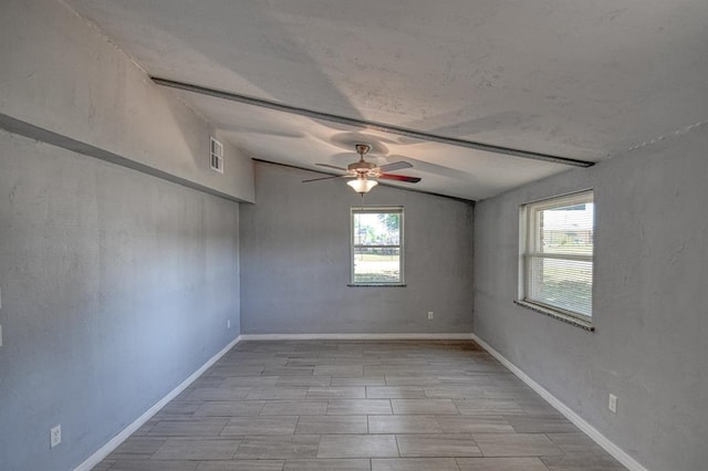 spare room featuring ceiling fan, light hardwood / wood-style floors, and vaulted ceiling