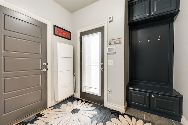 mudroom featuring dark tile patterned flooring