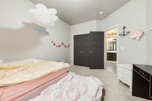 bedroom featuring light colored carpet and a closet