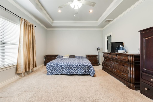 carpeted bedroom featuring a tray ceiling, ceiling fan, and ornamental molding