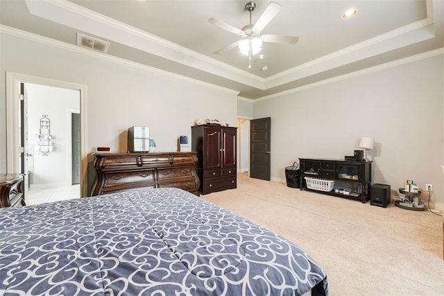 carpeted bedroom with a tray ceiling, ceiling fan, and ornamental molding