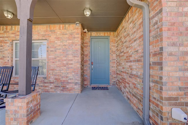 property entrance with brick siding