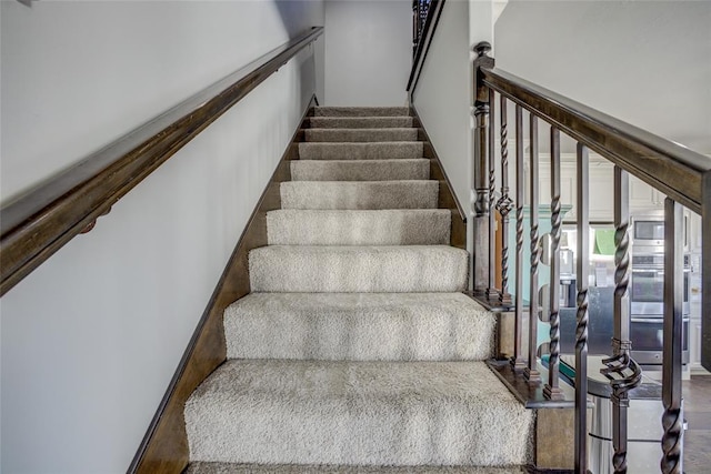 stairs featuring wood finished floors