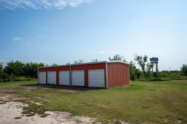 garage featuring a lawn