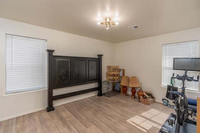 workout area with hardwood / wood-style floors