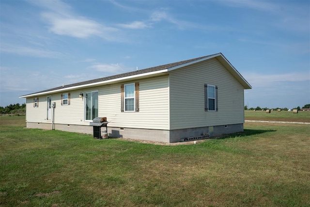 view of side of property with a lawn