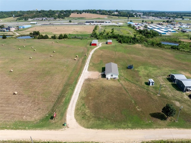 birds eye view of property with a rural view and a water view