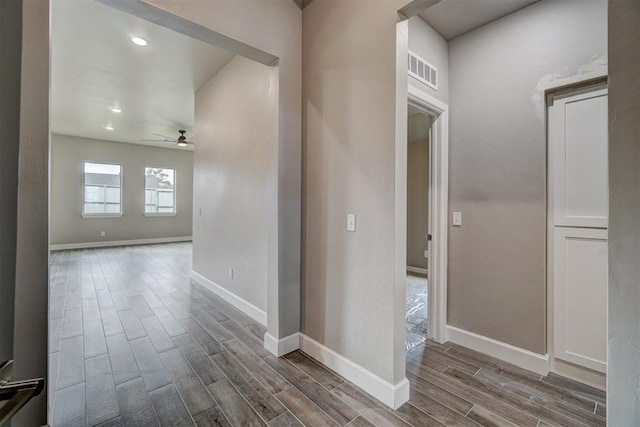 hallway with wood-type flooring