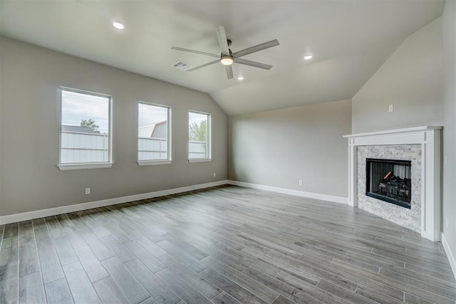 unfurnished living room featuring ceiling fan, light wood-type flooring, and vaulted ceiling