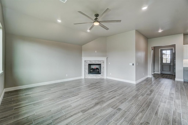 unfurnished living room with light hardwood / wood-style floors, ceiling fan, and lofted ceiling