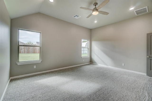 empty room with carpet flooring, ceiling fan, and vaulted ceiling