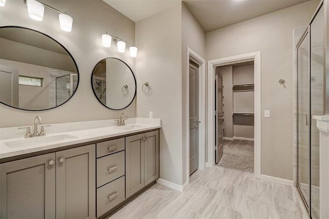 bathroom featuring vanity and a shower with door