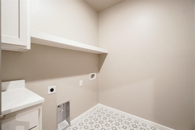 laundry area with hookup for an electric dryer, washer hookup, and cabinets