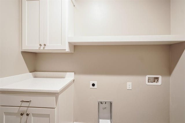 laundry room with electric dryer hookup, cabinets, and hookup for a washing machine