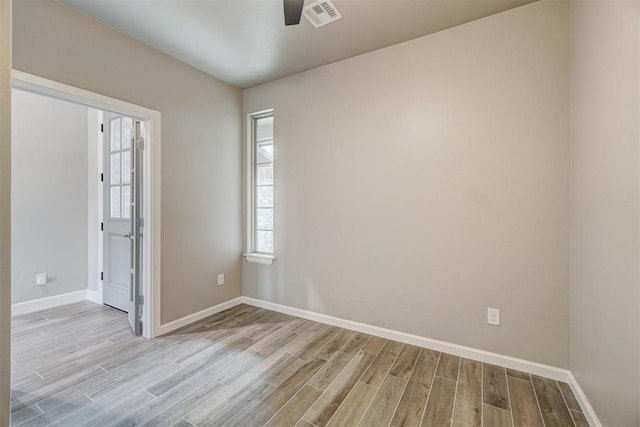 empty room featuring ceiling fan and light hardwood / wood-style floors