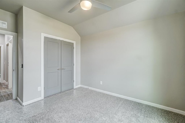 unfurnished bedroom with ceiling fan, a closet, and lofted ceiling