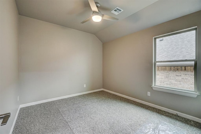 carpeted empty room with ceiling fan, a healthy amount of sunlight, and lofted ceiling