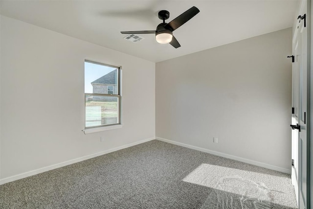 empty room with ceiling fan and carpet