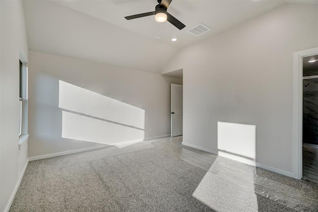 unfurnished room with ceiling fan, lofted ceiling, and light carpet