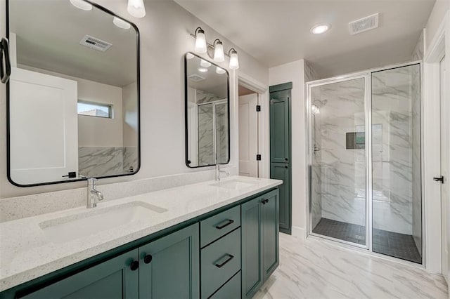 bathroom with vanity and a shower with shower door