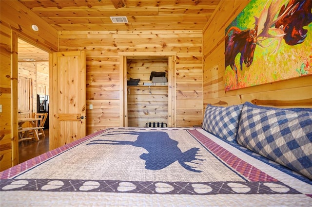 bedroom featuring wood walls, wood-type flooring, and wooden ceiling