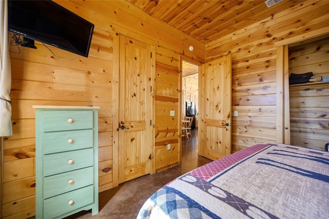 carpeted bedroom with wooden ceiling and wood walls