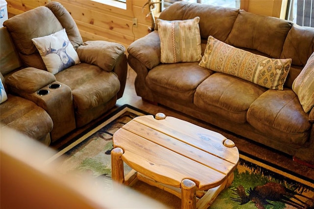 living room with plenty of natural light and wood walls