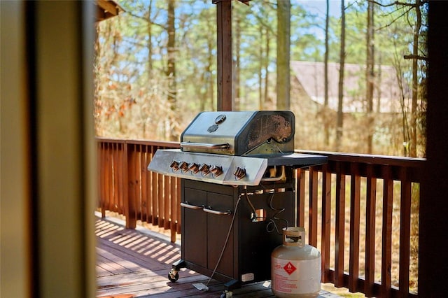 wooden deck featuring a grill