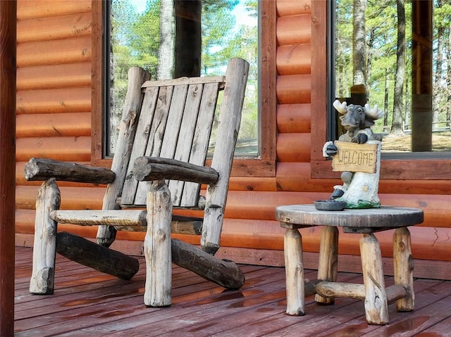 interior space with hardwood / wood-style floors and log walls