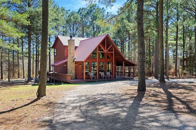 view of front facade with metal roof and faux log siding