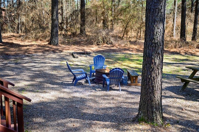 view of yard with an outdoor fire pit and a patio