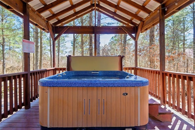 wooden terrace featuring a hot tub