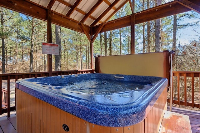 wooden deck with a hot tub