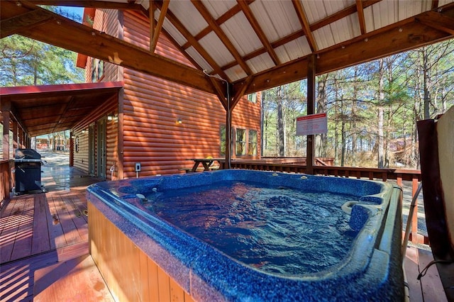 wooden deck featuring a grill and a hot tub