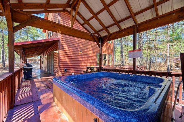 wooden terrace featuring a hot tub and area for grilling