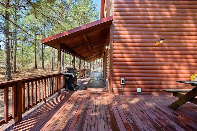 wooden deck featuring area for grilling