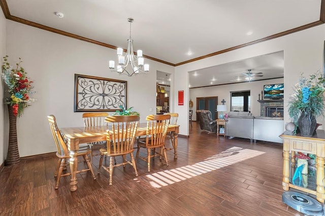 dining room featuring ceiling fan with notable chandelier, dark hardwood / wood-style floors, and ornamental molding