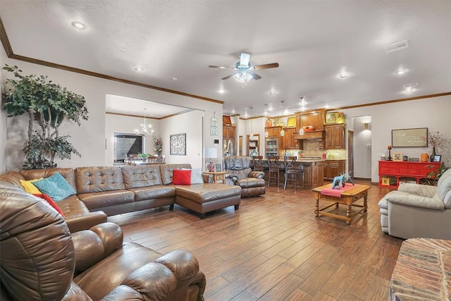 11335 N 1930th Rd, Sayre, OK 73662 - living room with ornamental molding, ceiling fan, dark wood-style flooring, a chandelier, and recessed lighting