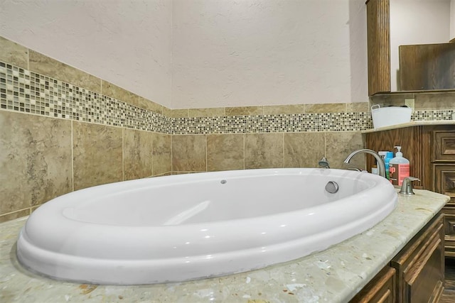 11335 N 1930th Rd, Sayre, OK 73662 - full bathroom featuring a garden tub, vanity, and a textured wall