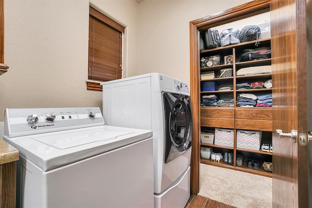 laundry area featuring separate washer and dryer and hardwood / wood-style flooring