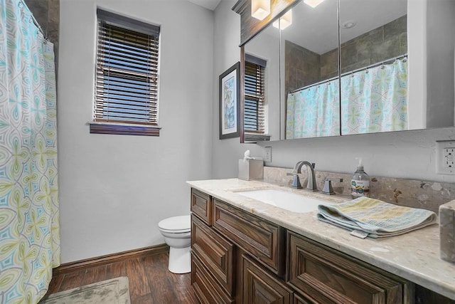 bathroom featuring wood-type flooring, vanity, and toilet