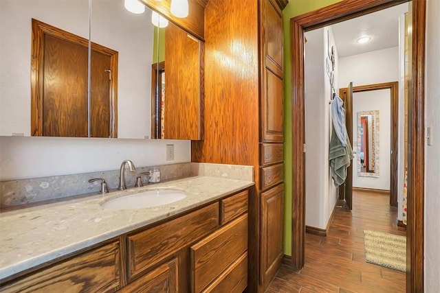 bathroom with vanity and hardwood / wood-style flooring