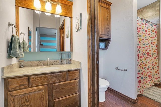 bathroom with hardwood / wood-style flooring, vanity, toilet, and a shower with shower curtain