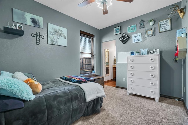 11335 N 1930th Rd, Sayre, OK 73662 - bedroom featuring carpet flooring, a textured wall, ceiling fan, and connected bathroom