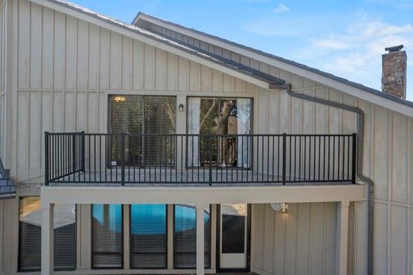 rear view of property featuring a balcony