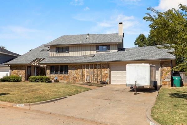 view of front of house with a garage and a front yard