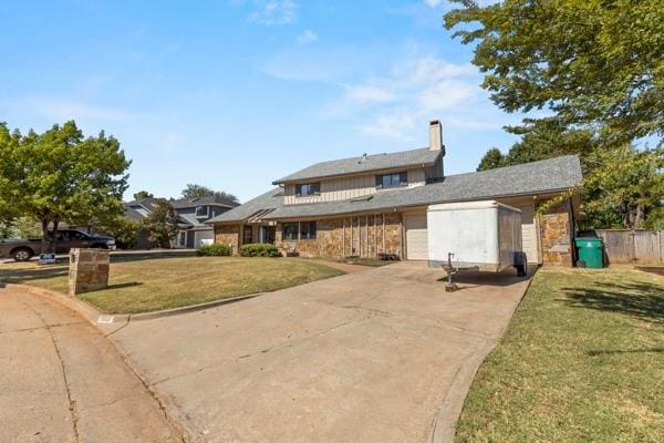 view of front of property with a garage and a front yard