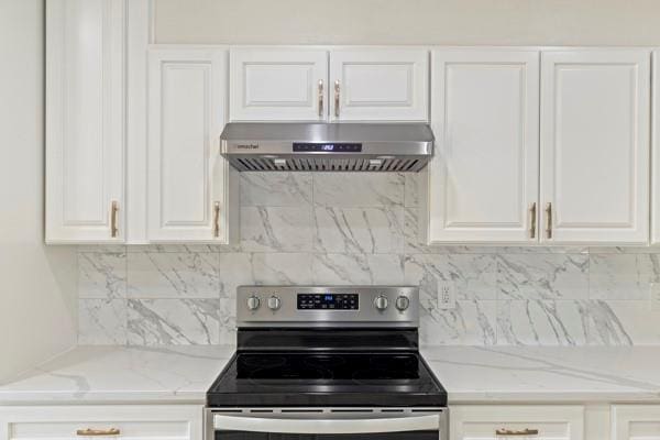 kitchen with tasteful backsplash, light stone counters, stainless steel electric range, and range hood